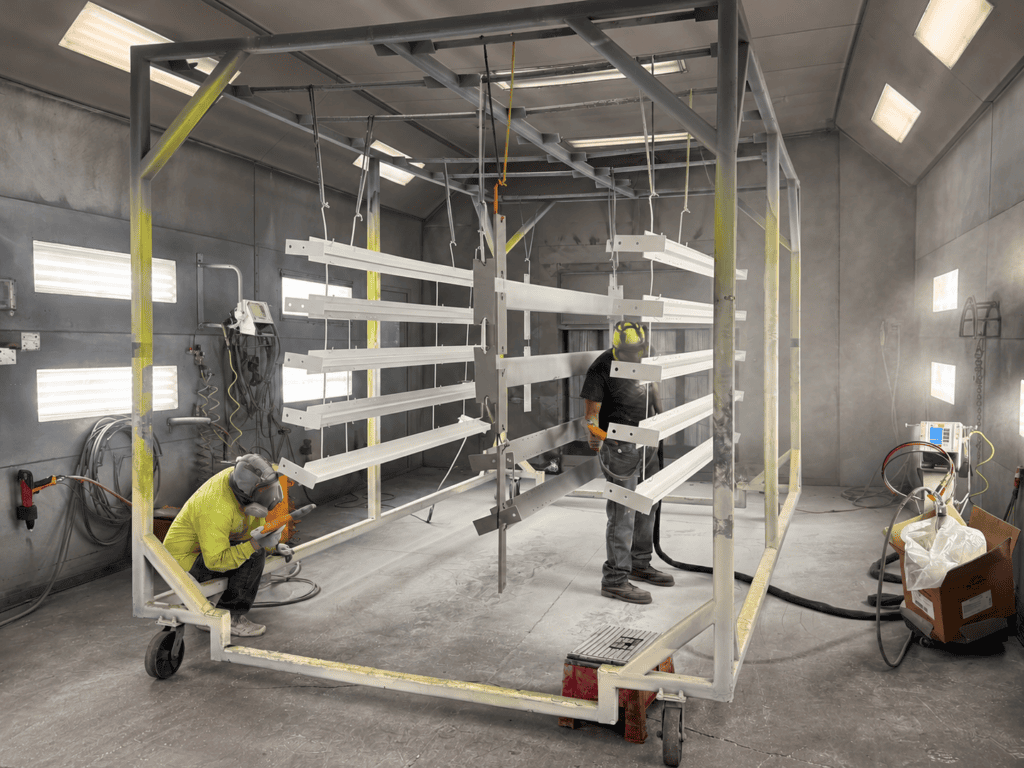 Data center production components in coating Two painters coating structural components on a rolling production rack in the Salt City shop